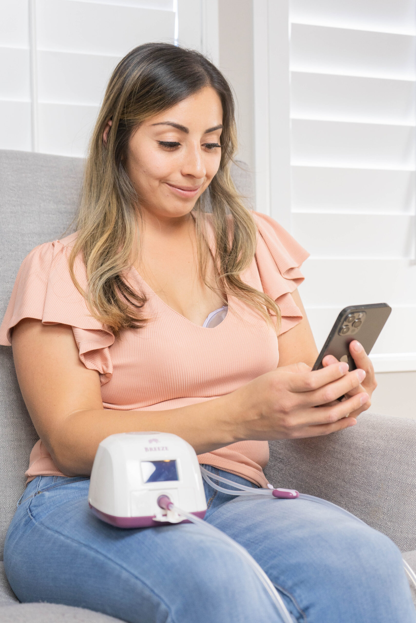 Woman on her phone getting breast pumping support.